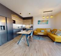 A kitchen in a 3-room apartment with a wooden decor floor and a yellow sofa.