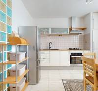 A kitchen in a 4-room apartment with a dining table and a glass wall.
