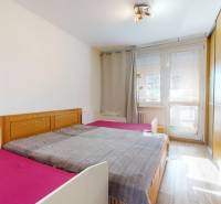 Bedroom with a wardrobe and wooden decor flooring in a 4-room apartment.