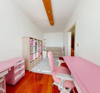Pink workspace in a 4-room apartment with wood-patterned flooring and storage space.