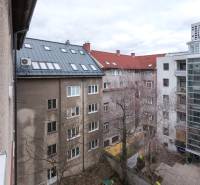 A view of apartment buildings and a courtyard in Bratislava - Ružinov with leafless trees.