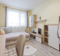 A bright room with a bed, a desk, and a wardrobe in a 4-room apartment.