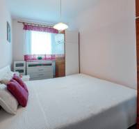 Bedroom with white bed linen and cabinets, 4-room apartment.