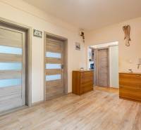 A hallway with wardrobes and dressers in a 4-room apartment, floor with wood decor.