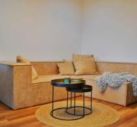 Living room in a 3-room apartment with a comfortable sofa and a floor with a wooden decor.