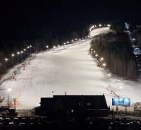 Night ski slope in Mýto pod Ďumbierom with lighting and a cable car.