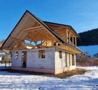 A cabin construction in Mýto pod Ďumbierom in a winter landscape with a wooden structure.