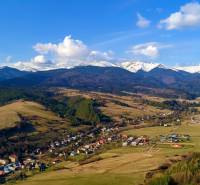 Aerial view of the picturesque village of Dolná Lehota with a mountain scenery behind it.