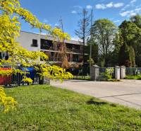 Building on Bodona Street with colorful containers, Studio apartment in a pleasant, green environment.