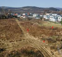 Land for residential use in Pezinok, surrounding houses, natural scenery, hills in the background.