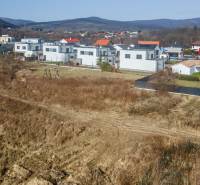 Land - housing in Pezinok with a view of modern development and the surrounding nature.