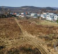 Plots - housing in Pezinok with views of the surrounding hills and modern houses.