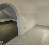 Interior of commercial spaces with a vaulted passage and combined flooring.