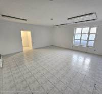 Empty commercial spaces with tiles and a window.