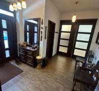 Interior of a family house with a wooden decor floor, storage space, and decorative lighting.