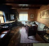 Living room in a family house with a wooden decor floor and comfortable seating.