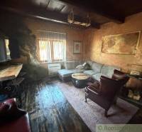 Living room in a family house with rustic furniture and a wooden decor floor.