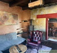 Living room in a family house with a leather armchair and a tiled stove.