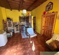 Yellow walls with traditional furniture, a tiled stove in a family house, a floor with a wooden decor.
