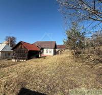 A family house in Lipovec with a wooden shelter and trees on the property.