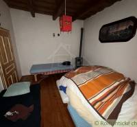 A room in a family house with wooden floor decor and simple furnishings.