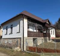 A family house in Lipovec with historical details, stone, and distinctive wooden veranda decor.
