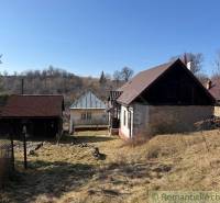 A family house in Lipovec with a stone garden and natural surroundings on a slope.