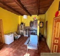 Interior of a family house with a wooden ceiling and yellow walls.