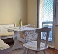 Dining area in a 2-room apartment with a wooden decor floor.