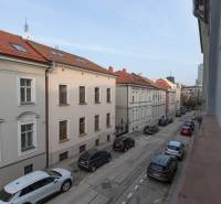 A view of Leškova Street in Bratislava - Old Town with a row of cars.