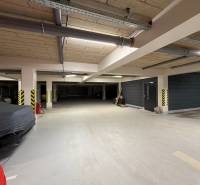 Underground parking lot with covered parking spaces and security features.
