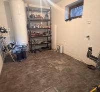 Storage space in a family house with a shelf and sports equipment, floor with wooden decor.