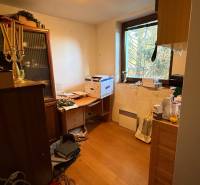A room in a family house with furnishings and a wooden decor floor.