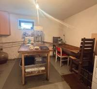 A kitchen in a family house with simple furniture and food processing equipment.