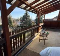 A wooden terrace of a family house in Lutila with a view of the garden and trees.