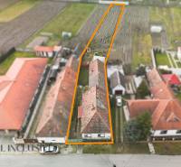 A family house in Topoľníky with a large plot, surrounded by the roofs of neighboring houses.