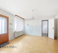 The interior of a family house with a wooden decor floor and white walls.