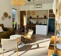 Interior of a family house with wicker accessories and a kitchen, floor with wooden decor.