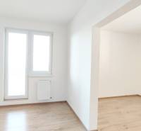 A bright room with a wood-decor floor in a 2-room apartment.