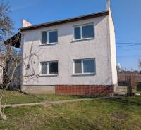 A family house in Lastovce on Nova Street with a white facade and a garden.