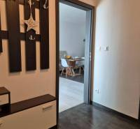 A hallway with folding furniture and a view into the dining room in a 3-room apartment.