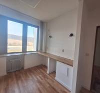 Commercial premises with wood-patterned flooring and a large window.