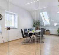 Glass walls, wood-patterned floor, and stairs in the office.