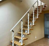 A staircase with wooden steps and railing, a floor with a wooden decor in the office.