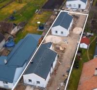 A residential area of family houses in Borčice surrounded by gardens and neighboring houses.