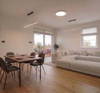 Living room in a family house with a dining table and a wooden decor floor.