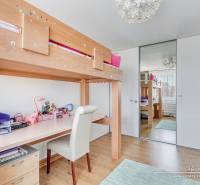 Children's room with a bed and a desk, wooden decor flooring, 4-room apartment.