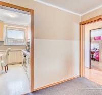 Kitchen and children's room in a 4-room apartment with a wooden decor floor.
