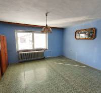 Interior in a family house with a blue wall, carpet, and pendant light.
