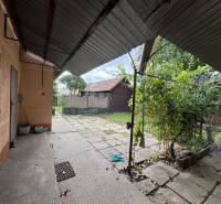 A family house in Komárno with a spacious yard and a gazebo, surrounded by greenery.